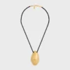 Celine Dafila Shell Necklace in Brass with Gold Finish and Silk Celine Dafila Shell Necklace in Brass with Gold Finish and Silk